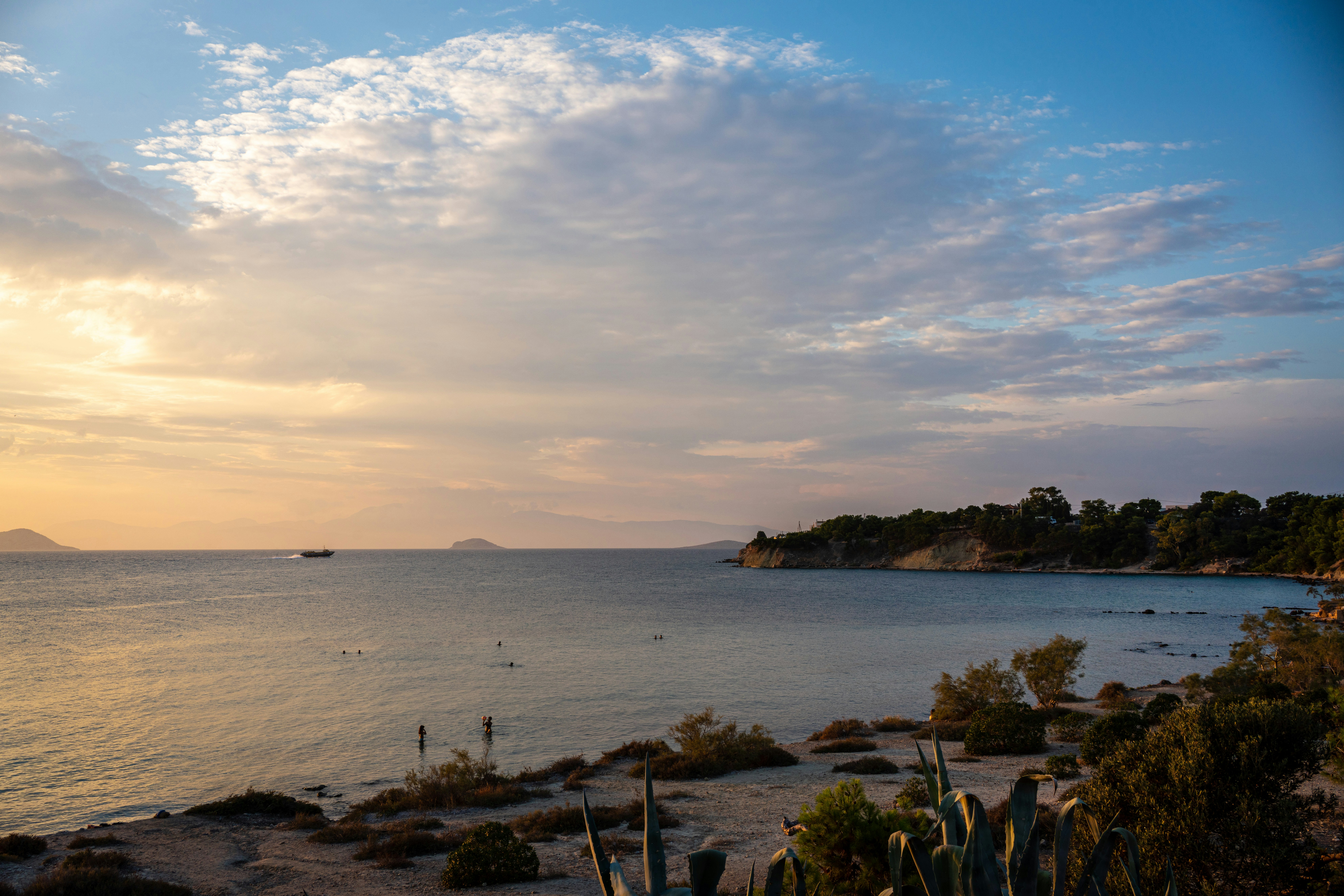 a body of water with a boat in the distance, 