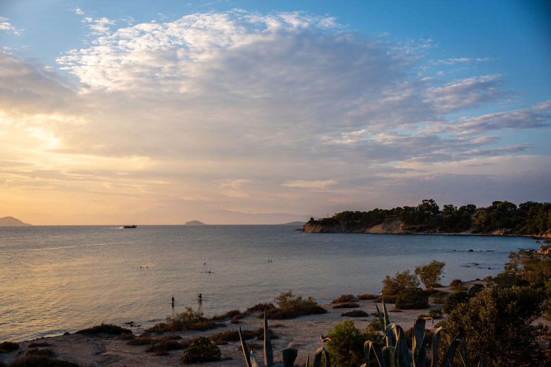 a body of water with a boat in the distance,