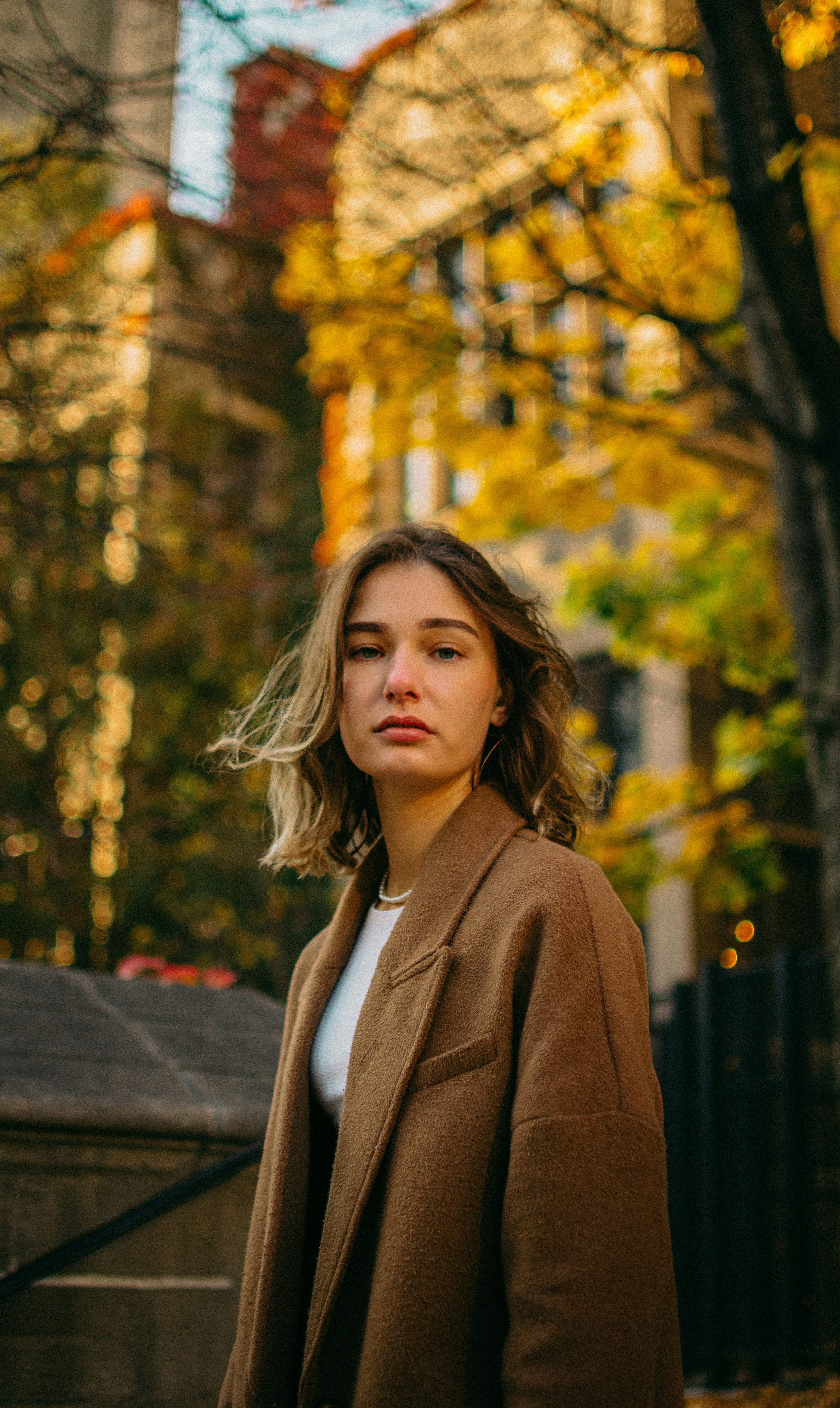 a woman standing in front of a tree