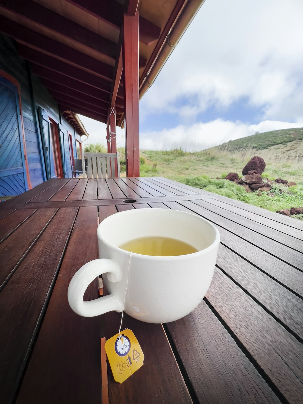 a cup of tea sitting on a wooden deck