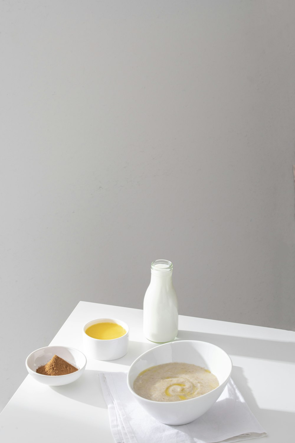 a white table topped with bowls of food