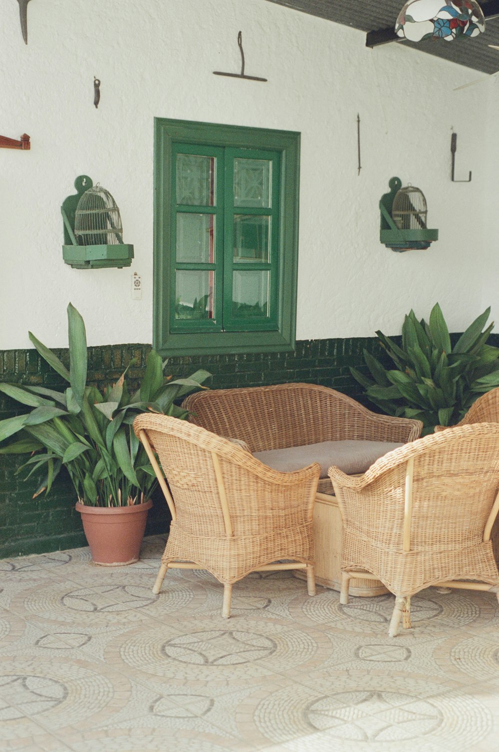 a couple of wicker chairs sitting on top of a patio