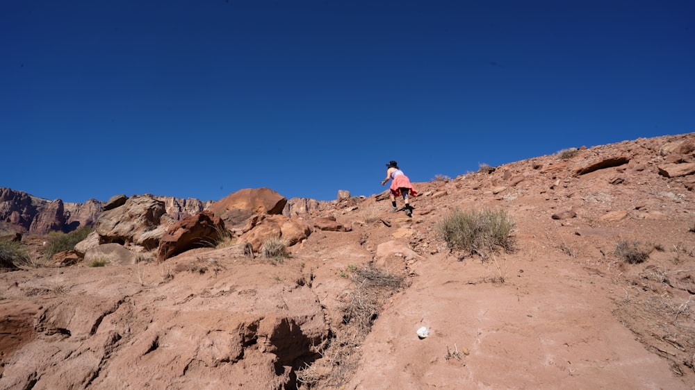 a person standing on top of a rocky hill