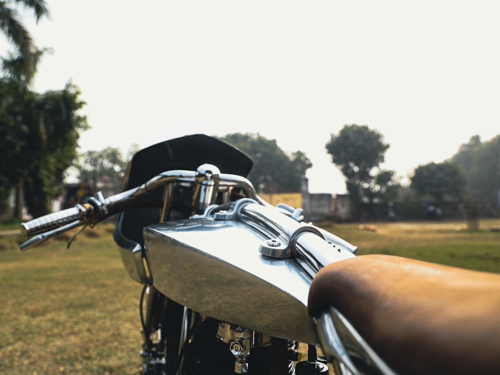 a close up of a motorcycle parked in a field