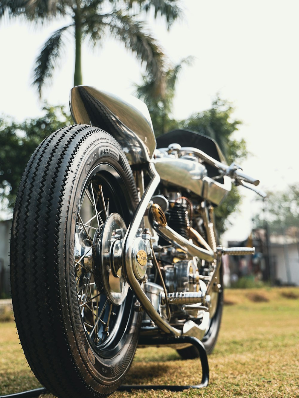 a motorcycle parked on top of a lush green field