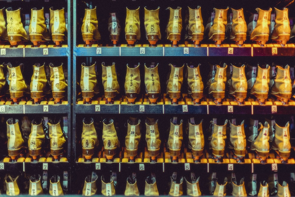 a row of shelves filled with lots of different colored vases