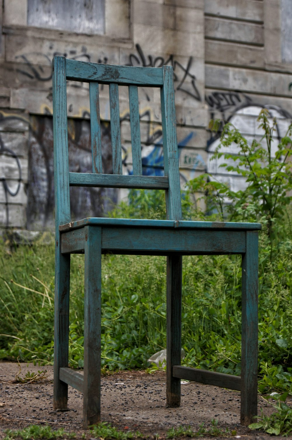 a wooden chair sitting in front of a building