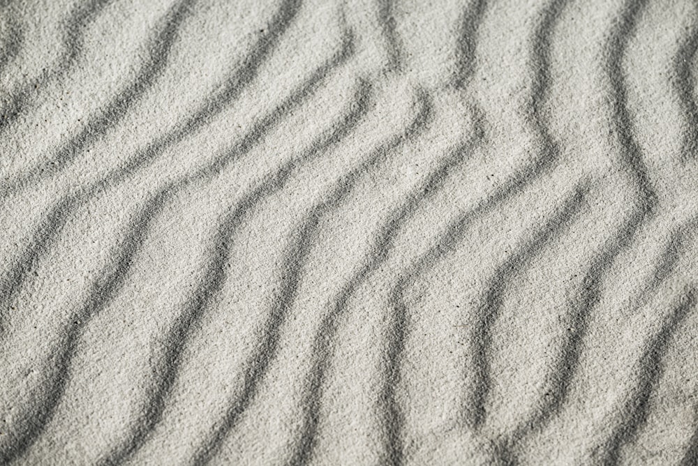 a close up of sand with wavy lines