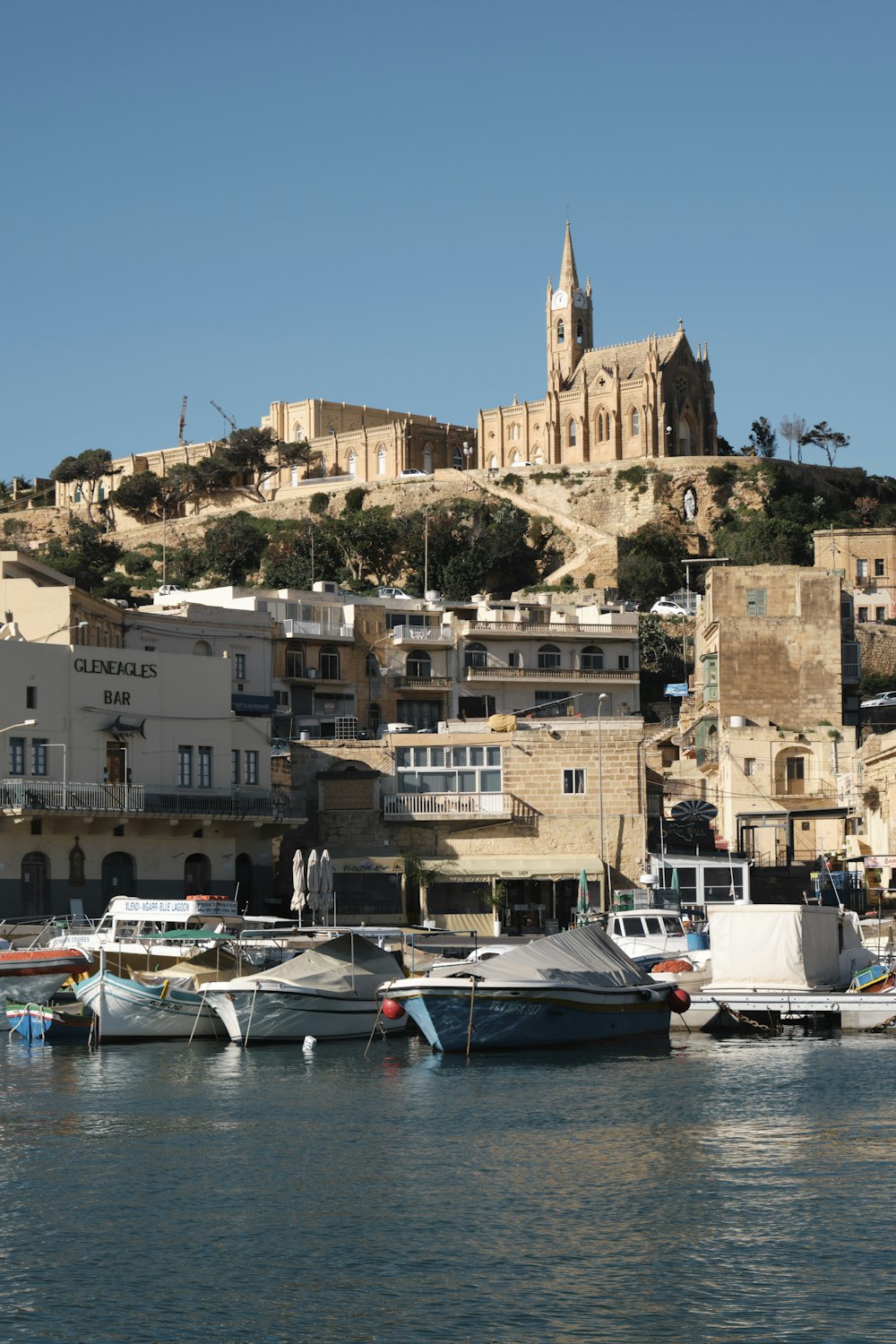 a group of boats sitting in a harbor next to a city