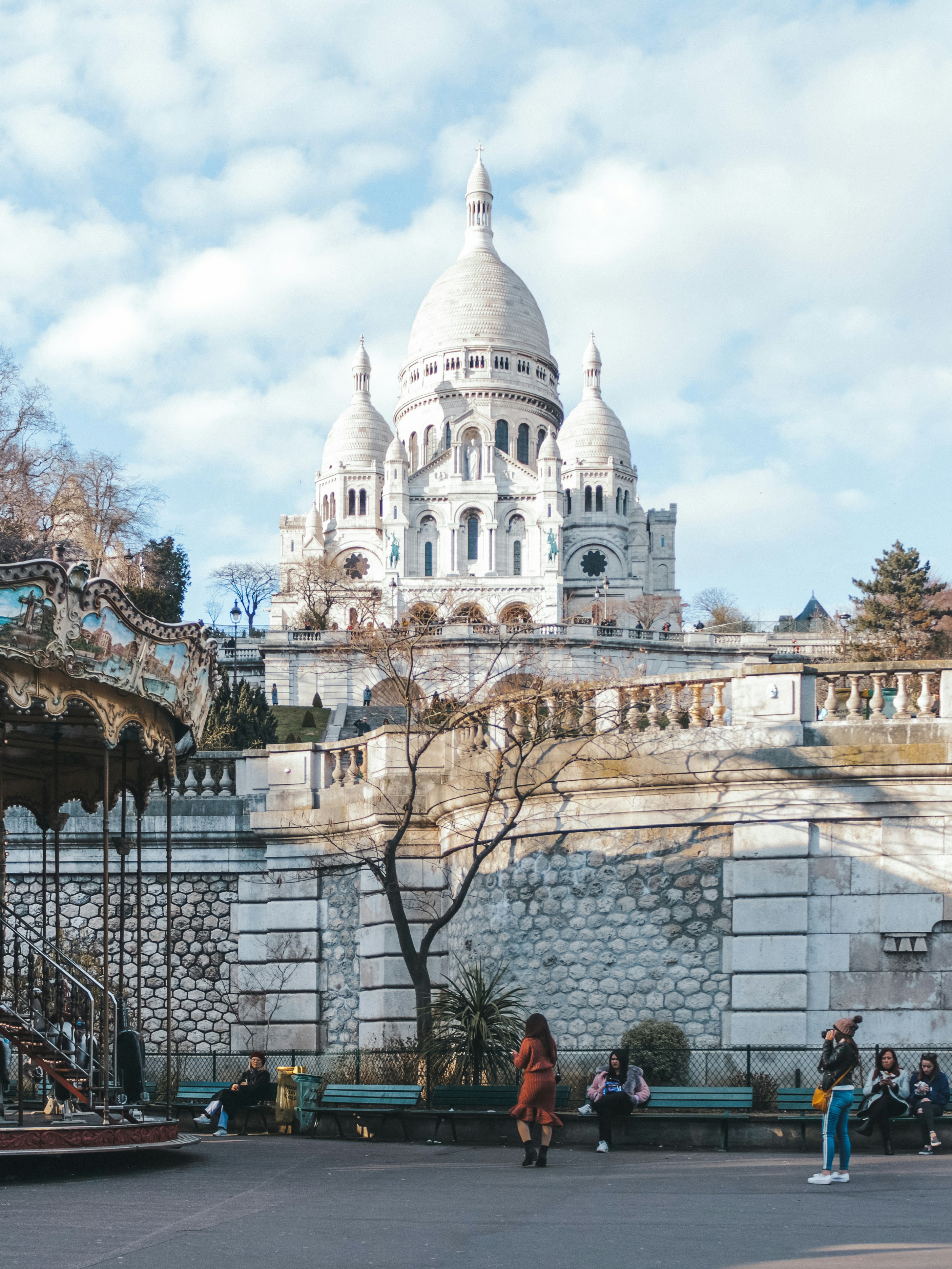 a group of people sitting on a bench in front of a building