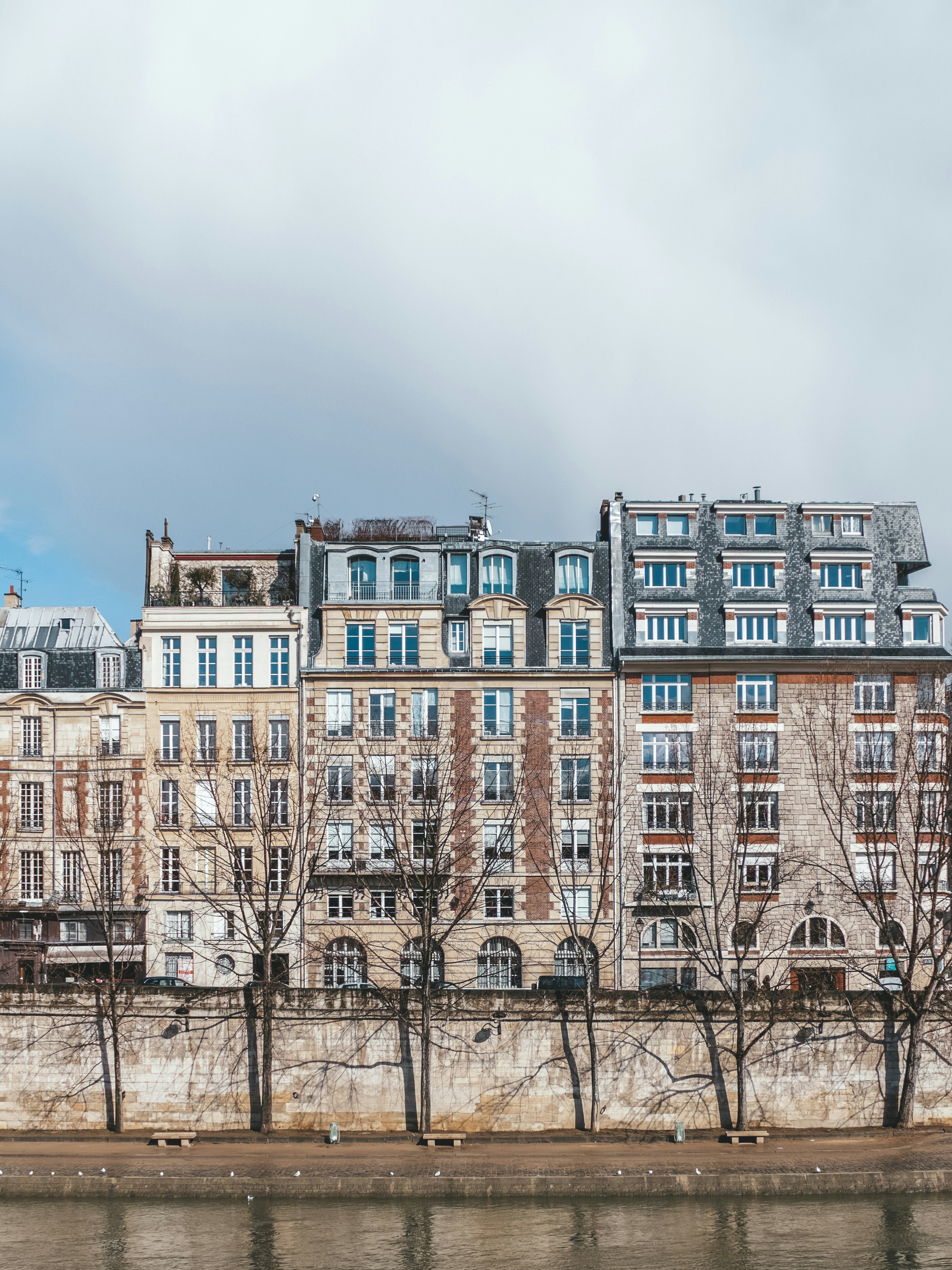 a row of buildings next to a body of water