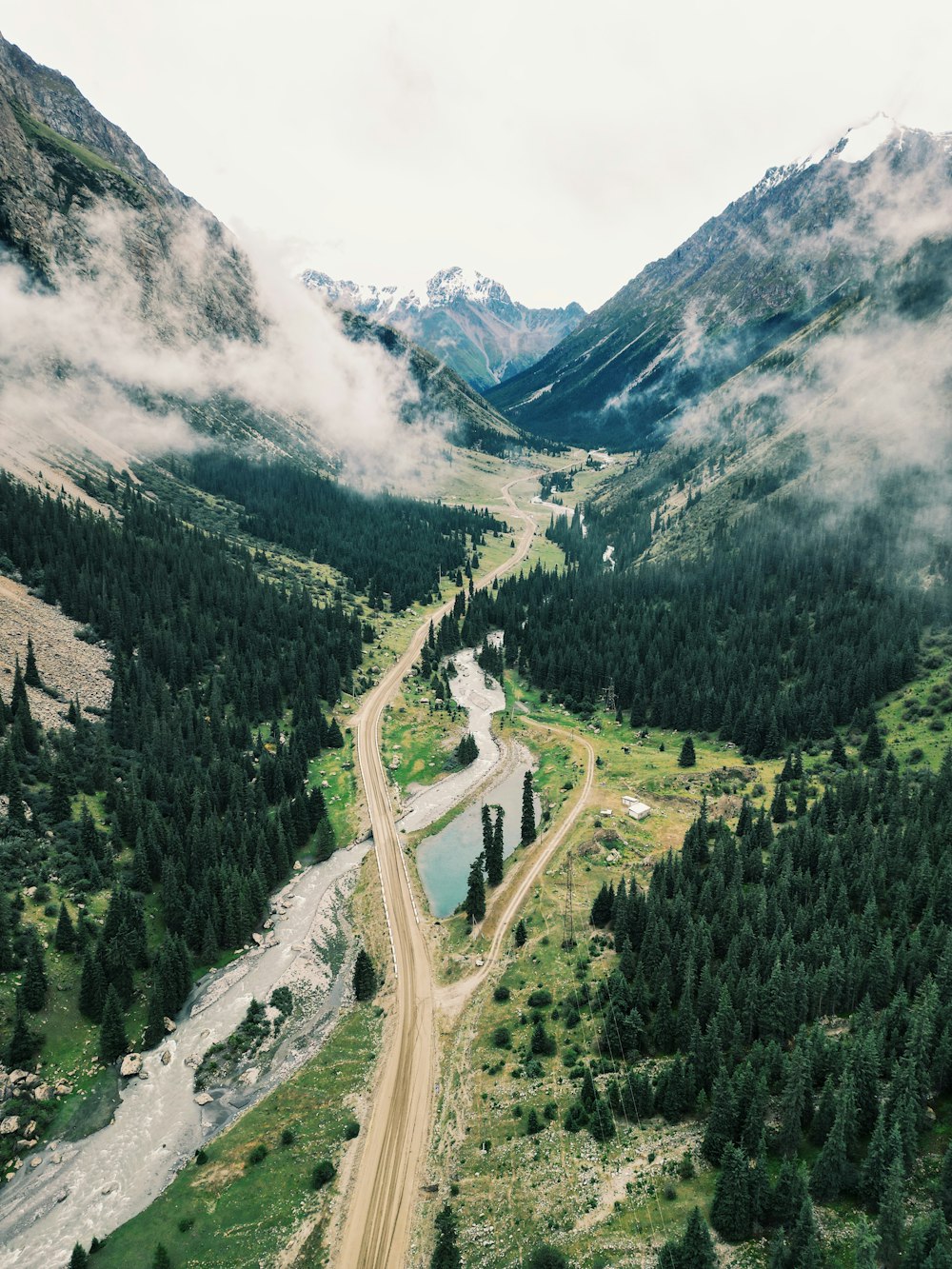 an aerial view of a dirt road in the mountains