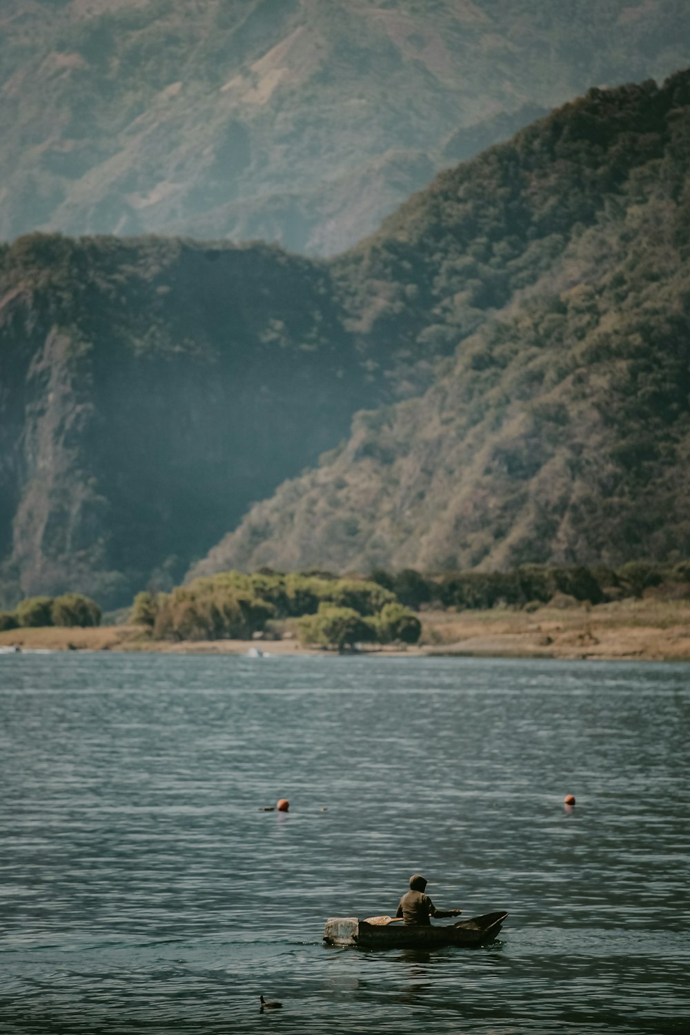 a person in a small boat on a large body of water