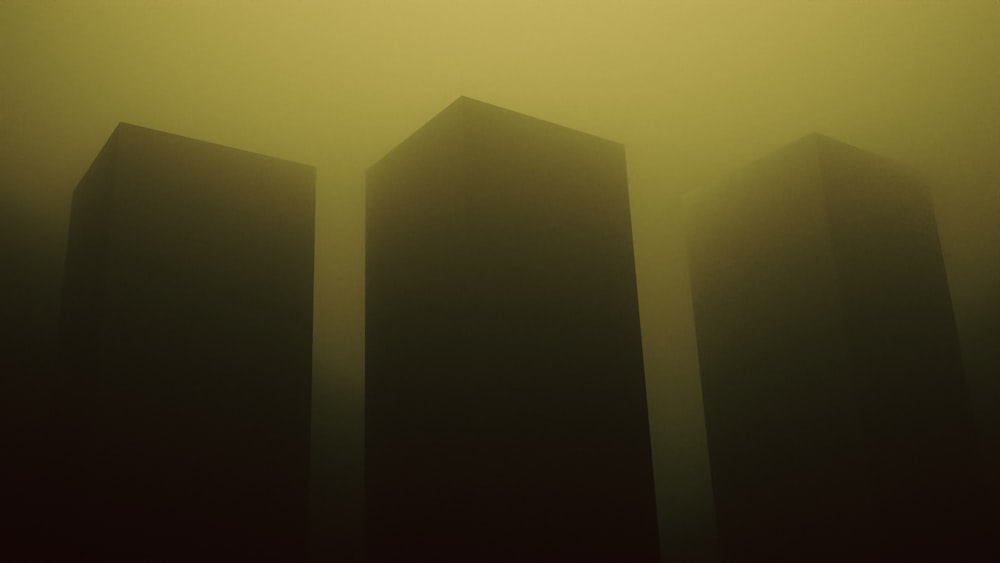 a group of tall buildings in a foggy area