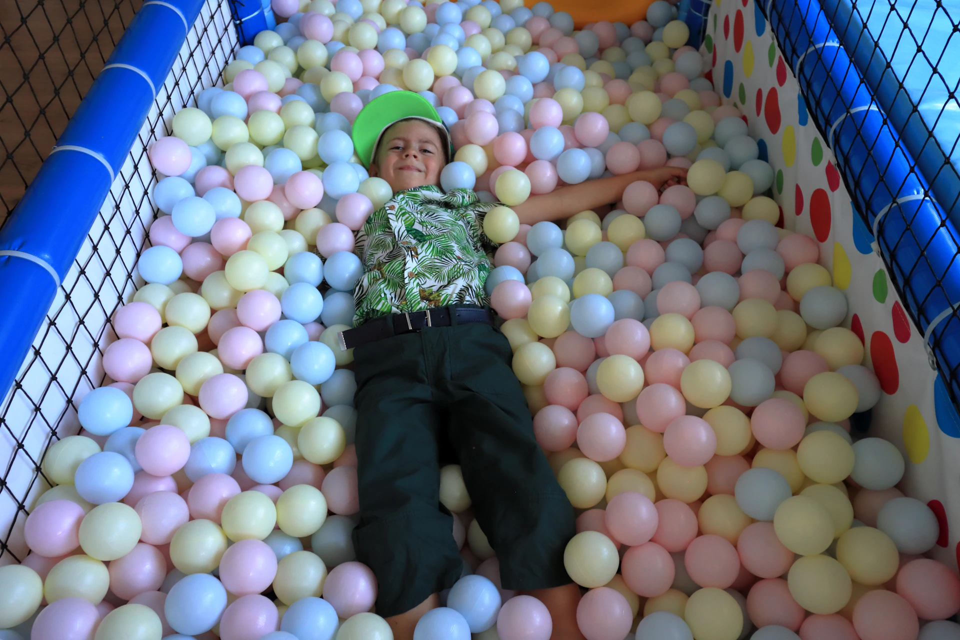 Indoor ball pit filled with vibrant balls and happy kids enjoying the pelotero