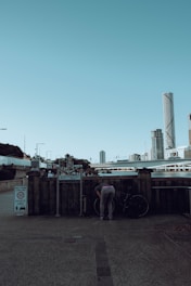 A cyclist locking their bike at a designated parking spot in the city.