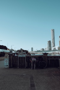 A cyclist locking their bike at a designated parking spot in the city.