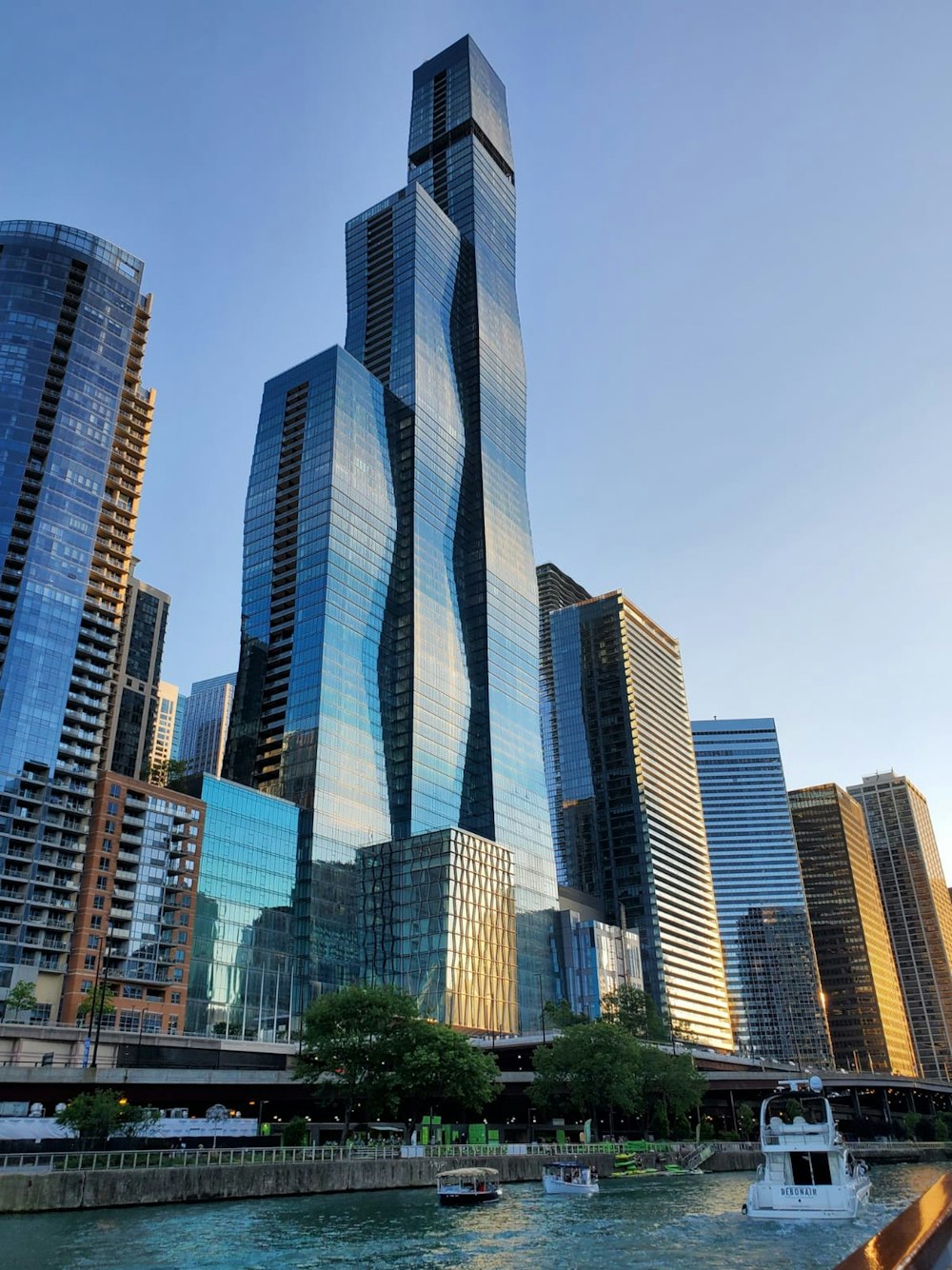 a group of tall buildings next to a body of water