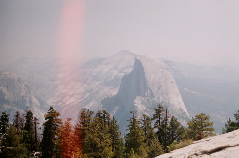 a view of a mountain with a rainbow in the sky