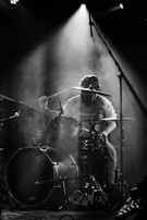 A drummer in action, surrounded by dynamic lighting.