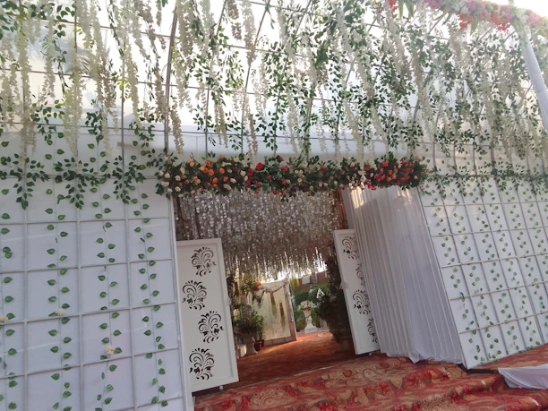 Grand entrance of Panchbadan Royale adorned with traditional floral decorations and warm lighting.