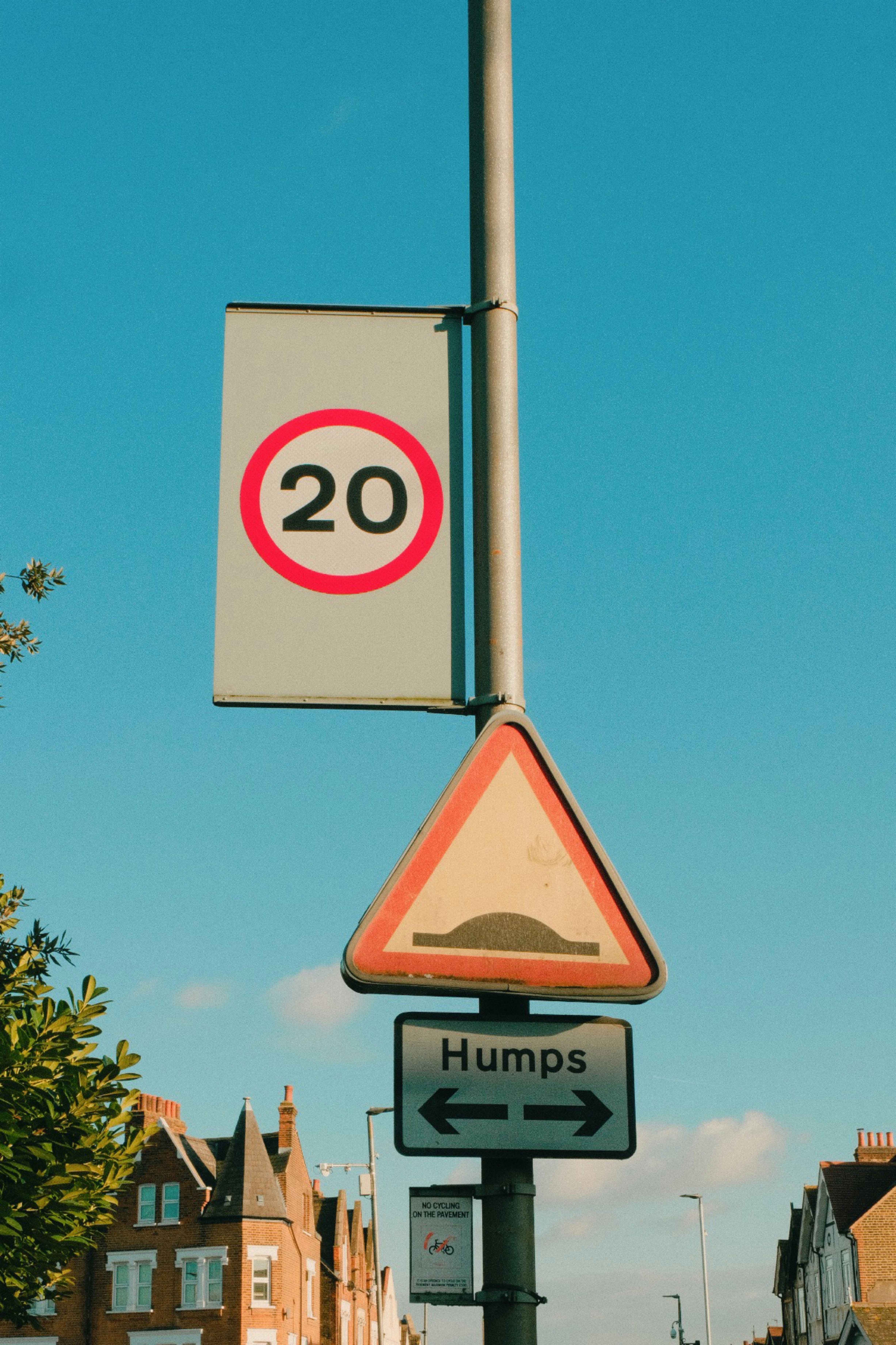 A street sign with a speed limit sign above it photo – Free Symbol ...