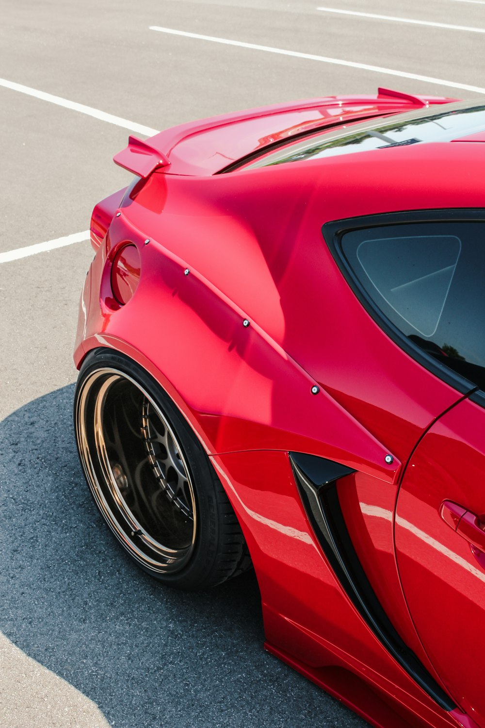 a red sports car parked in a parking lot