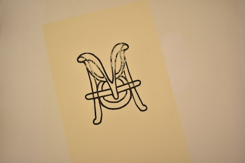 An elegant black and white monogram style logo for a luxury boutique.