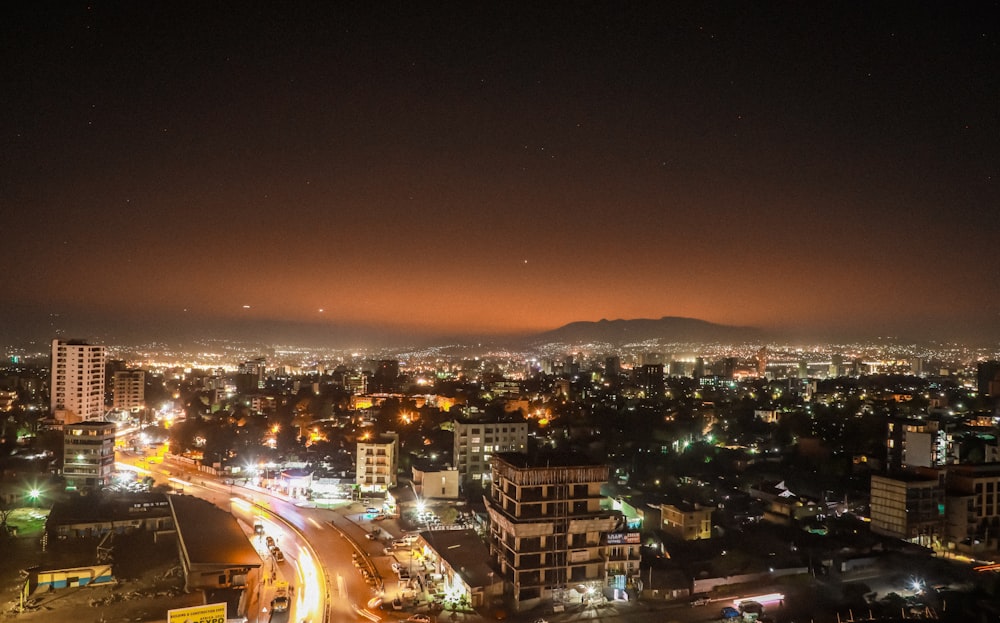 a view of a city at night from the top of a building