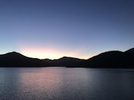 A serene lakeside view at dusk, perfect for pondering shared moments and memories.