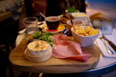 a wooden table topped with bowls of food