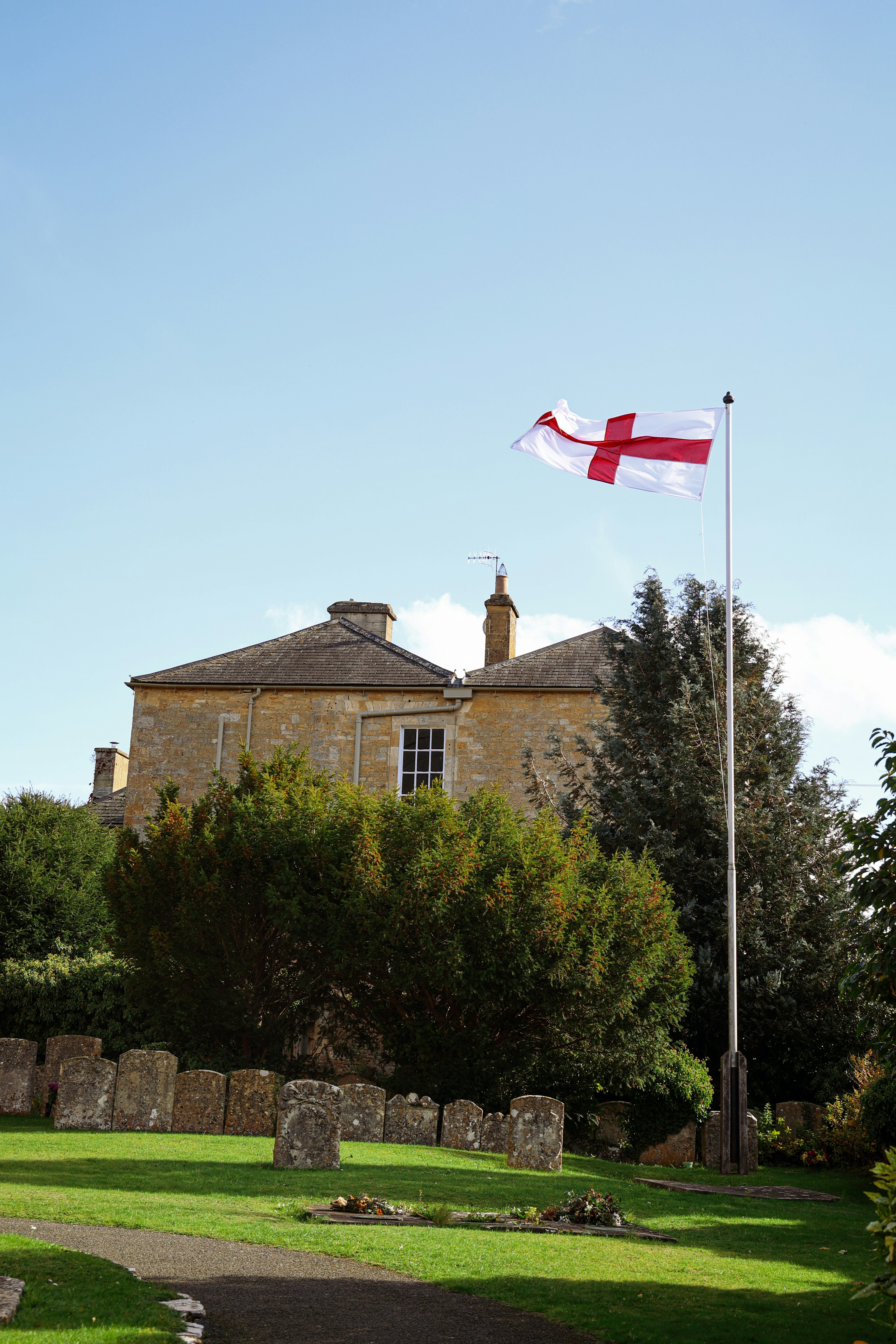 a flag flying in front of a large building