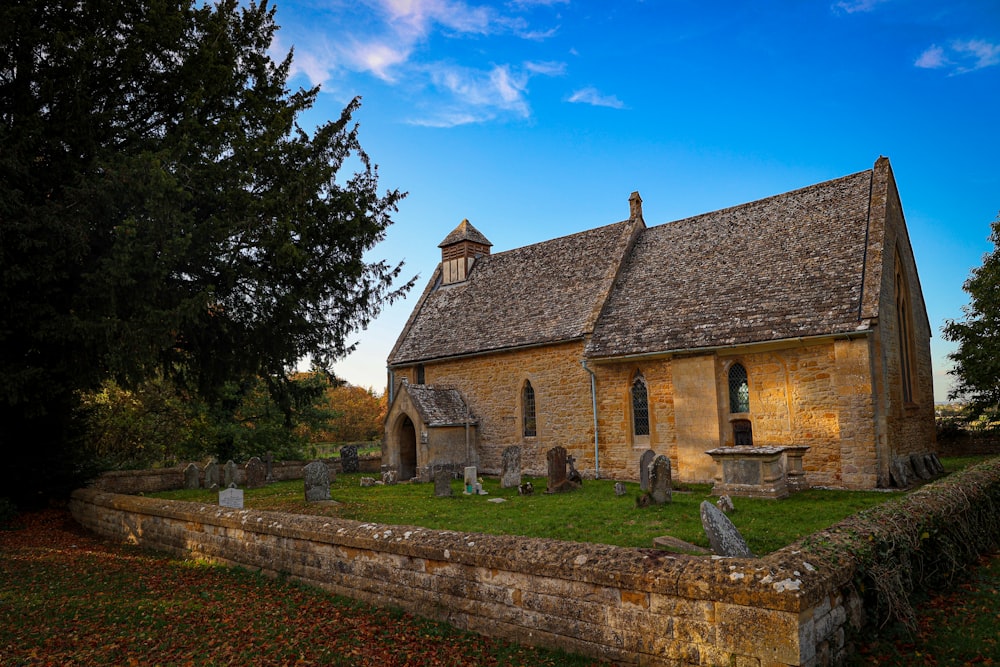 a stone church with a steeple and a stone wall