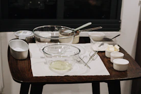 a wooden table topped with a bowl of food