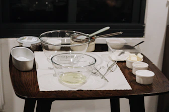 a wooden table topped with a bowl of food