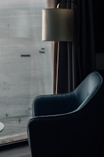 Inviting sitting area in the lake house room featuring a plush armchair and a view of the water.