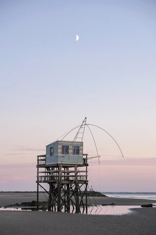 A cozy beachside cabin at sunset, perfect for a peaceful getaway.