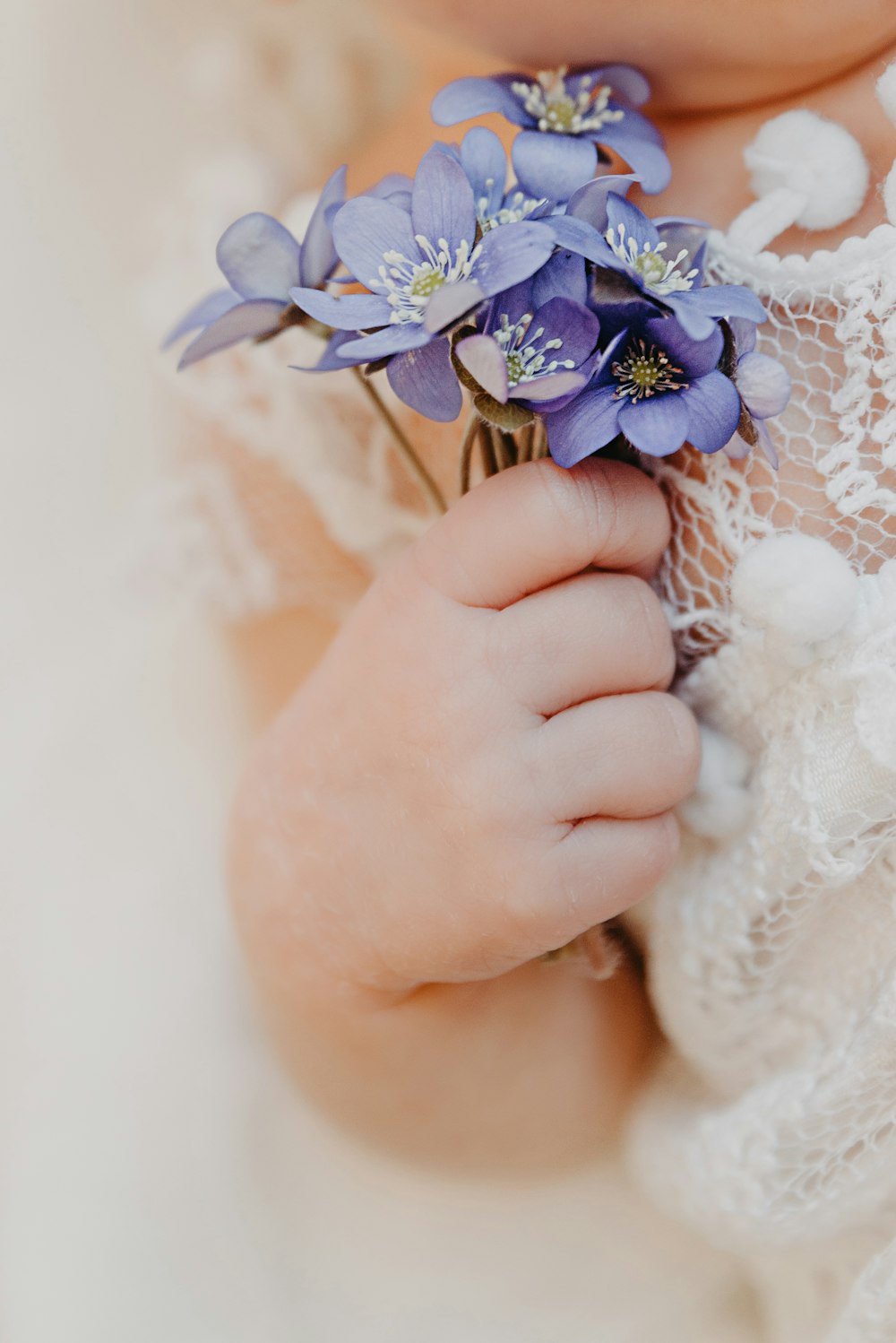 a close up of a person holding flowers