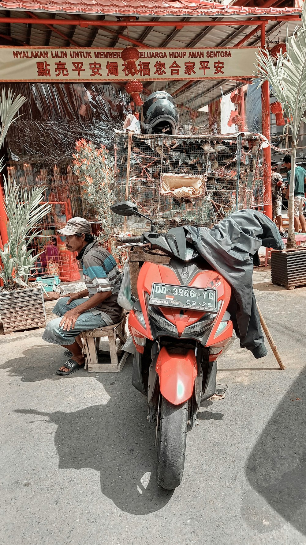 a red motorcycle parked in front of a store
