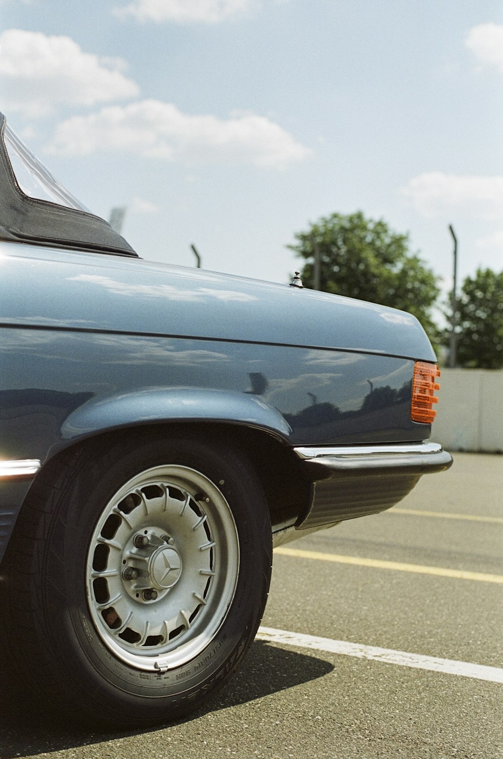 a blue car parked in a parking lot