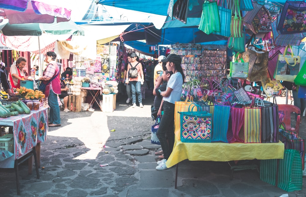 a group of people standing around a market