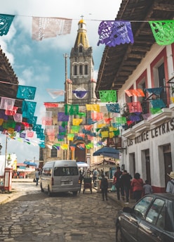 a group of people walking down a cobblestone street