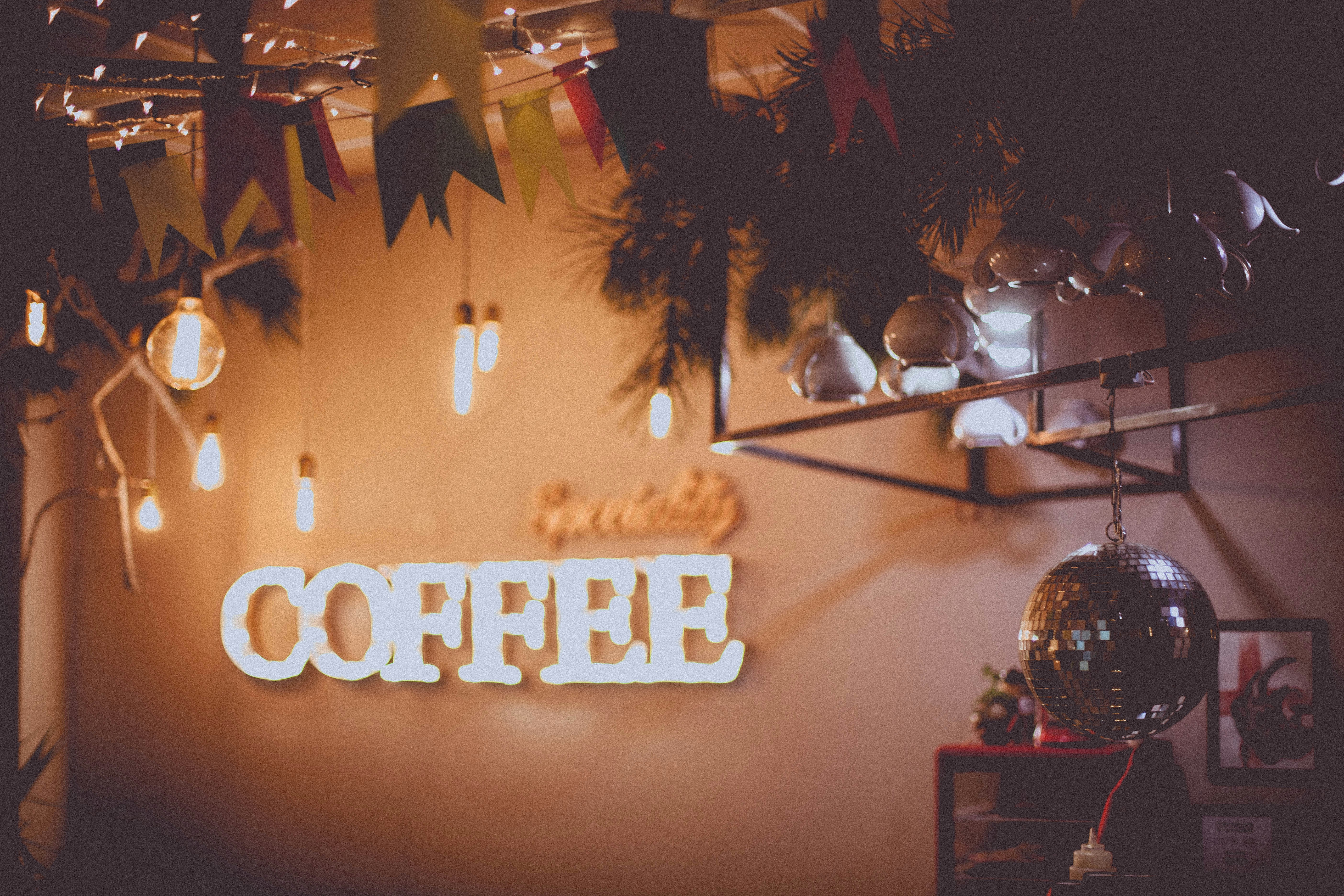 a sign that reads coffee hanging from a wall