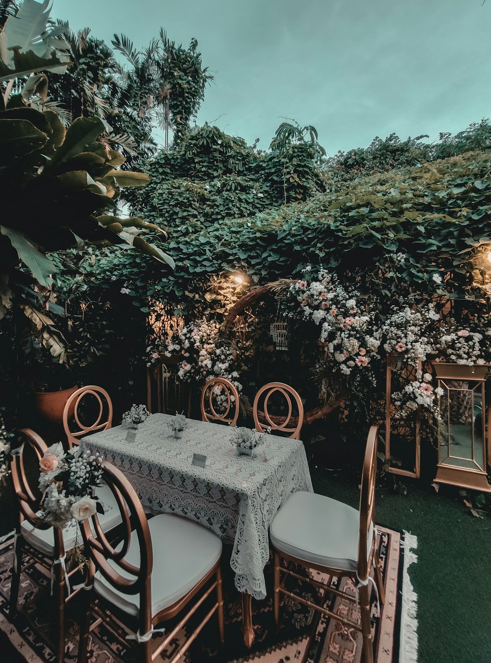 a table and chairs with a table cloth on it