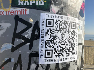 Close-up of a souvenir tag with a QR code against a beach background