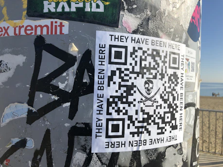 Close-up of a souvenir tag with a QR code against a beach background