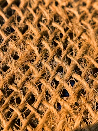 Close-up of a rustic burlap tablecloth with natural textures and earthy tones.