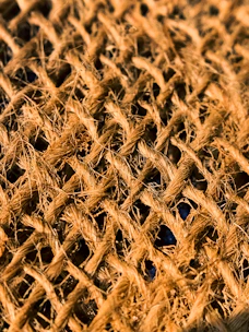 Close-up of a rustic burlap tablecloth with natural textures and earthy tones.