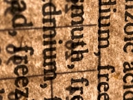Close-up of a hand inspecting the sharpness of printed text on paper.