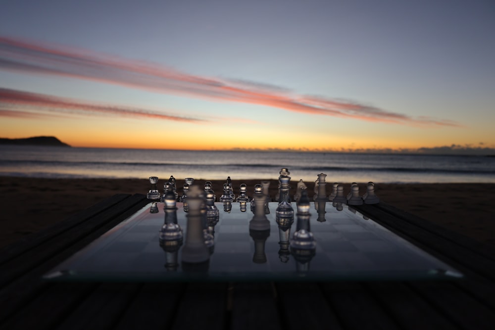 a glass table with a chess set on top of it